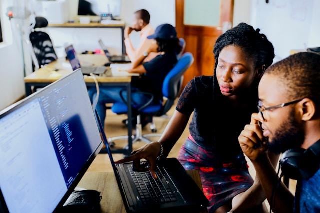 woman and man sitting in front of monitor credit: Desola Lanre-Ologun via Unsplash